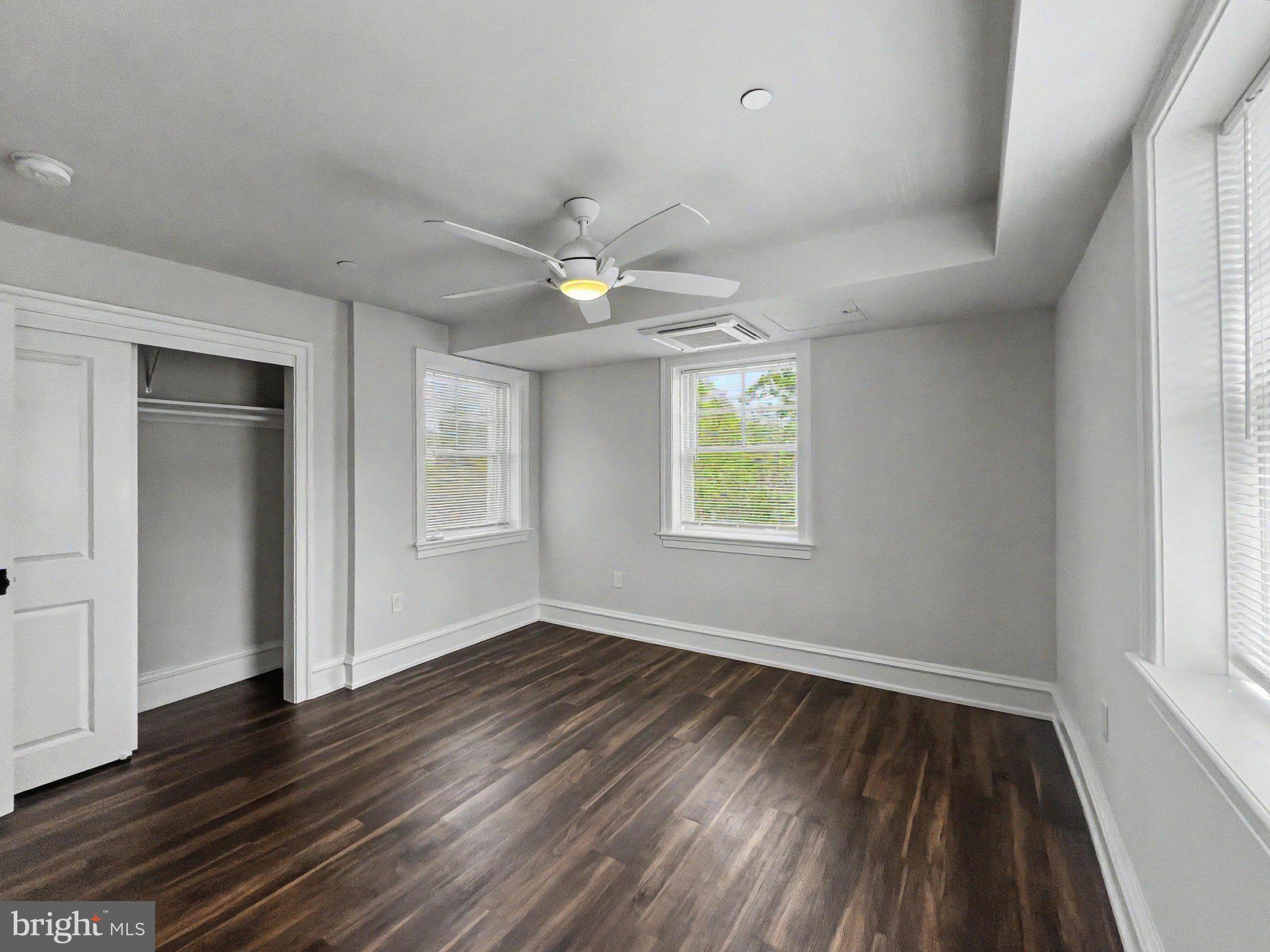 1 Pennsylvania Avenue, Unit 1 Wayne, PA 19087 - Photo 13 of 22 an empty room with wooden floor and windows