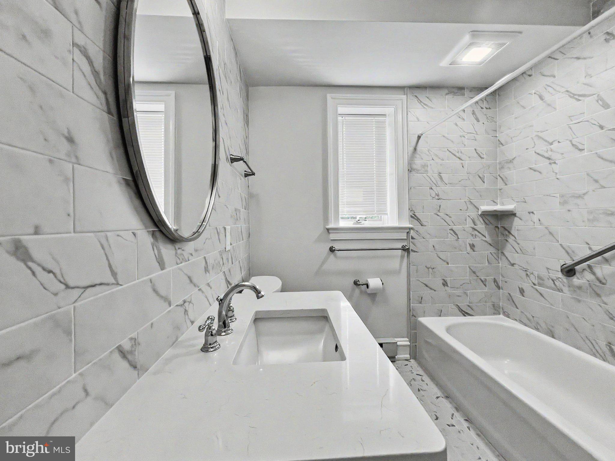 1 Pennsylvania Avenue, Unit 1 Wayne, PA 19087 - Photo 14 of 22 a bathroom with a sink a bathtub and a shower