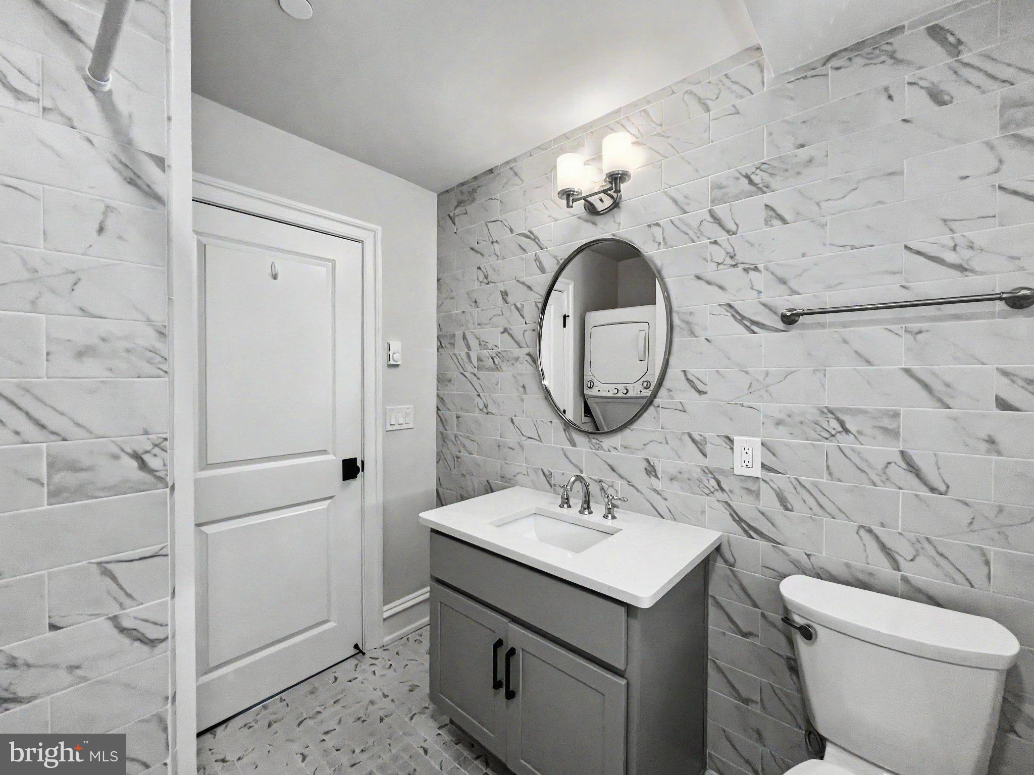 1 Pennsylvania Avenue, Unit 1 Wayne, PA 19087 - Photo 17 of 22 a bathroom with a sink and a mirror