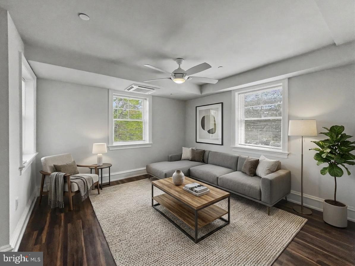 1 Pennsylvania Avenue, Unit 1 Wayne, PA 19087 - Photo 2 of 22 a living room with furniture a table and a large window