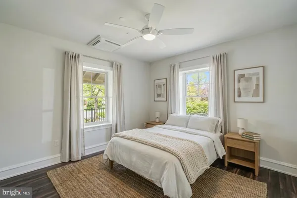 a bedroom with a large bed a chandelier and a window