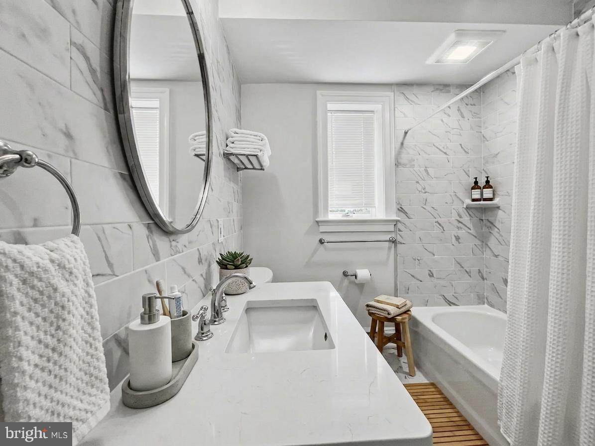 1 Pennsylvania Avenue, Unit 1 Wayne, PA 19087 - Photo 4 of 22 a bathroom with a sink a bathtub and a shower