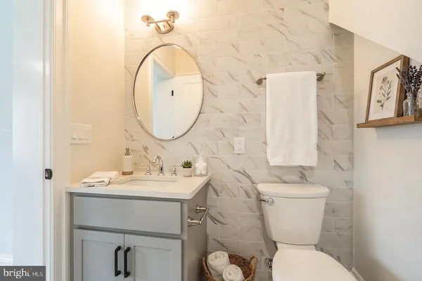 a bathroom with a sink mirror and toilet