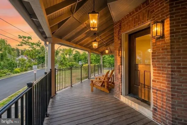 a view of a balcony with chairs and wooden floor
