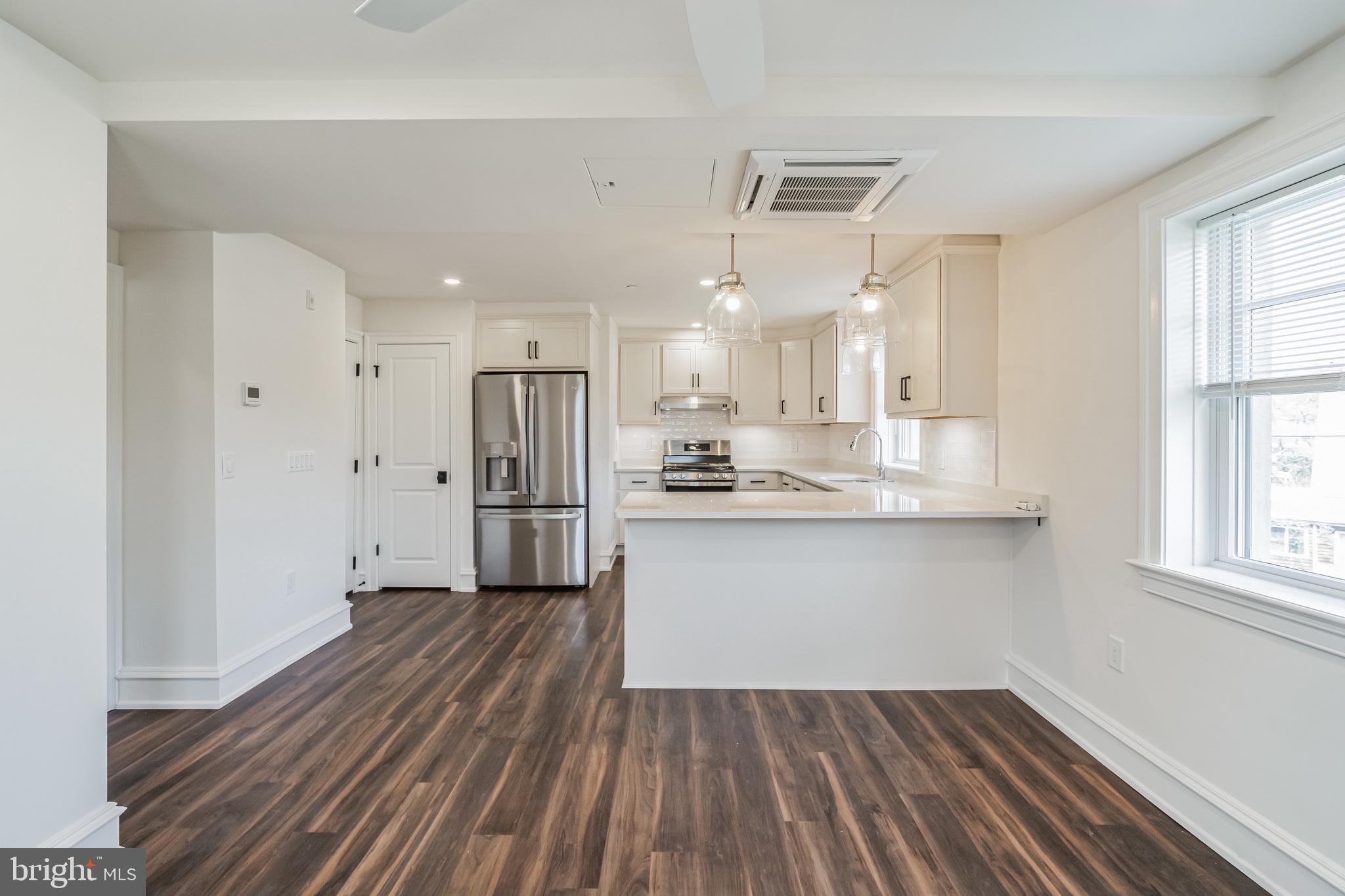 1 Pennsylvania Avenue, Unit 1 Wayne, PA 19087 - Photo 7 of 22 a kitchen with stainless steel appliances granite countertop a refrigerator and a sink