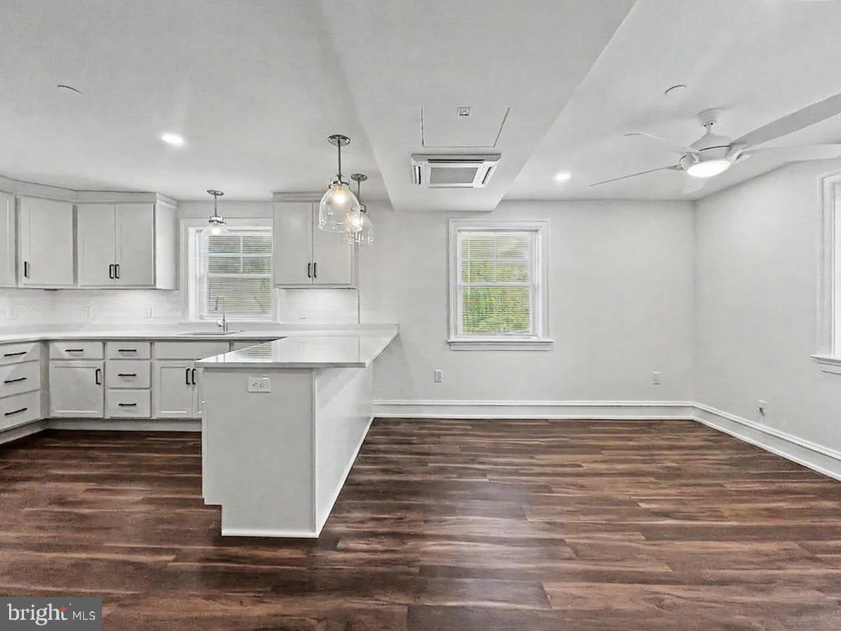 1 Pennsylvania Avenue, Unit 1 Wayne, PA 19087 - Photo 8 of 22 a large kitchen with kitchen island a stove a sink dishwasher and a oven with wooden floor