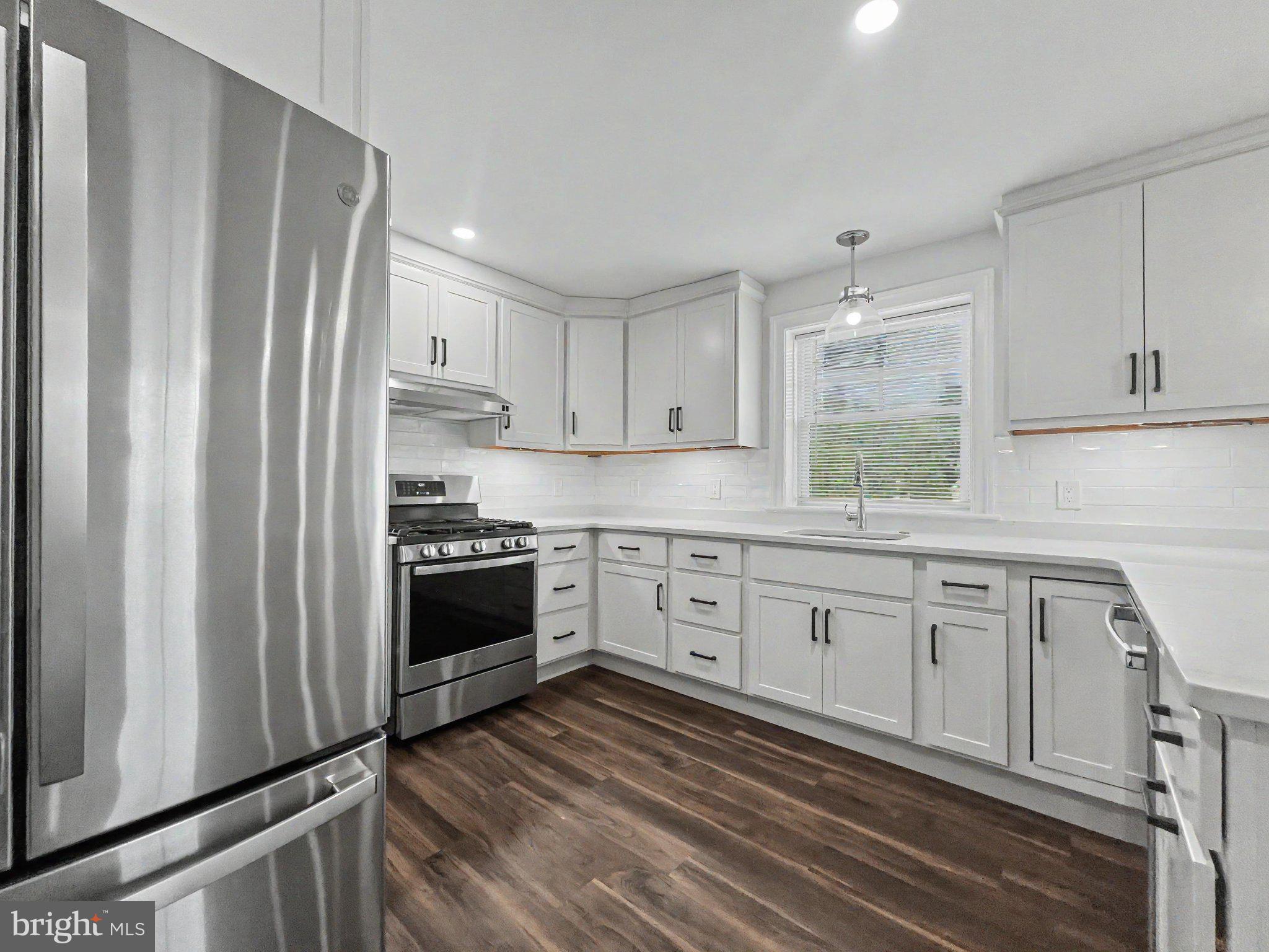 1 Pennsylvania Avenue, Unit 1 Wayne, PA 19087 - Photo 10 of 22 a kitchen with stainless steel appliances white cabinets and a refrigerator