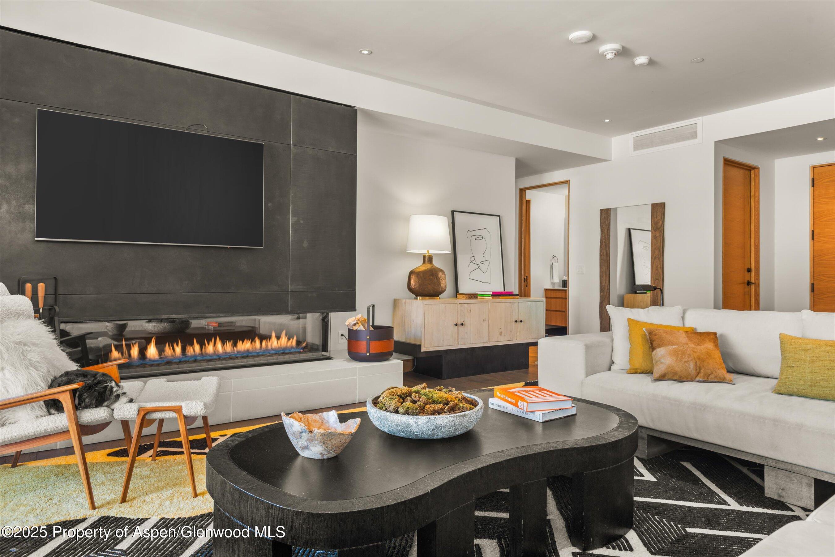 45 Wood Road, Unit 501 Snowmass Village, CO 81615 - Photo 12 of 44 a view of a dining room with furniture and a flat screen tv