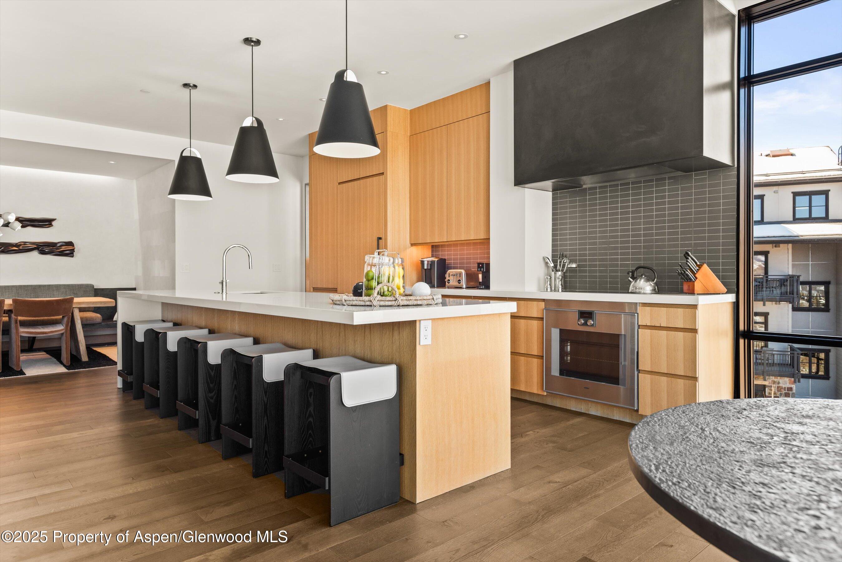 45 Wood Road, Unit 501 Snowmass Village, CO 81615 - Photo 22 of 44 a kitchen with kitchen island granite countertop a sink counter top space and stainless steel appliances