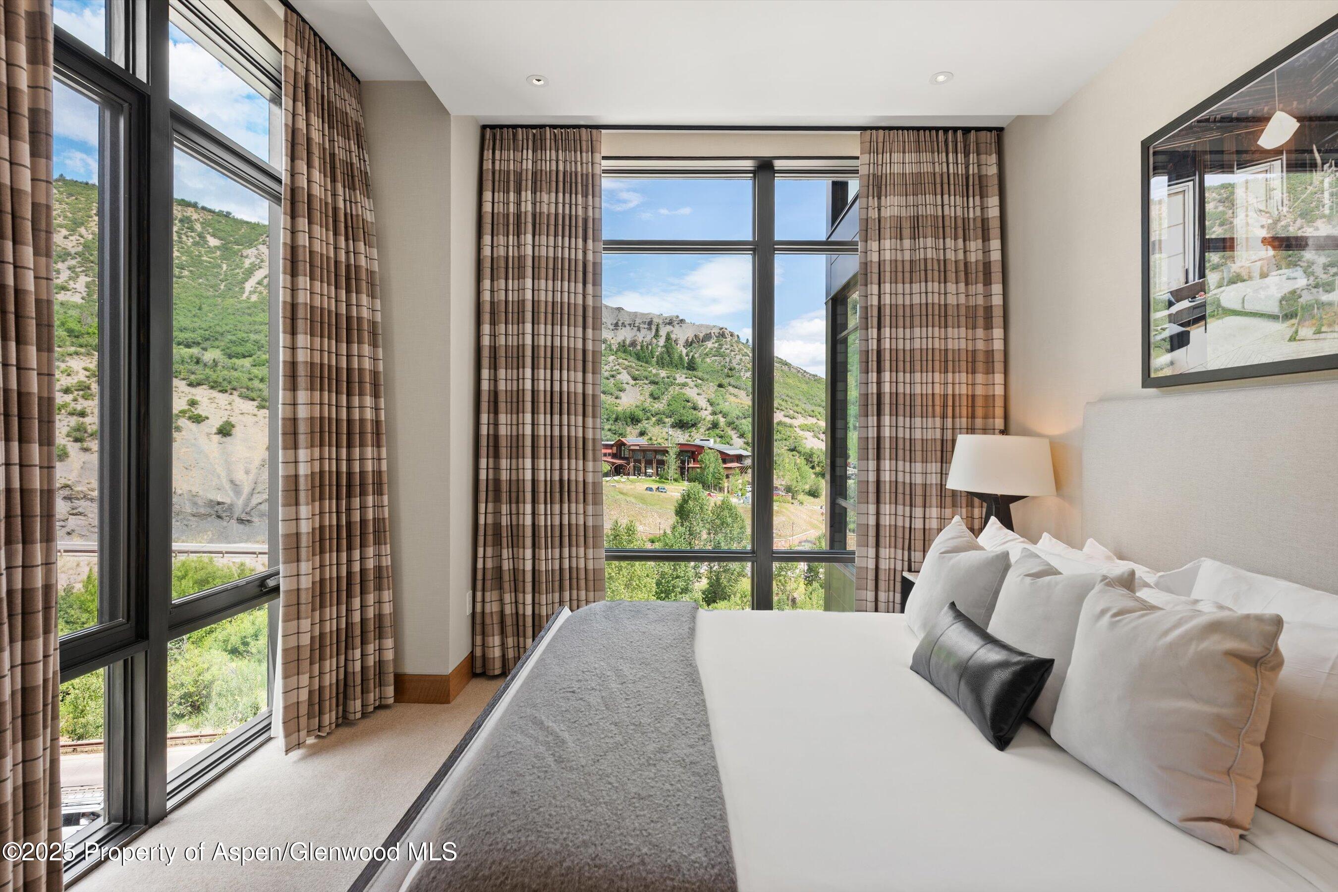 45 Wood Road, Unit 501 Snowmass Village, CO 81615 - Photo 23 of 44 a bedroom with a bed and wooden floor