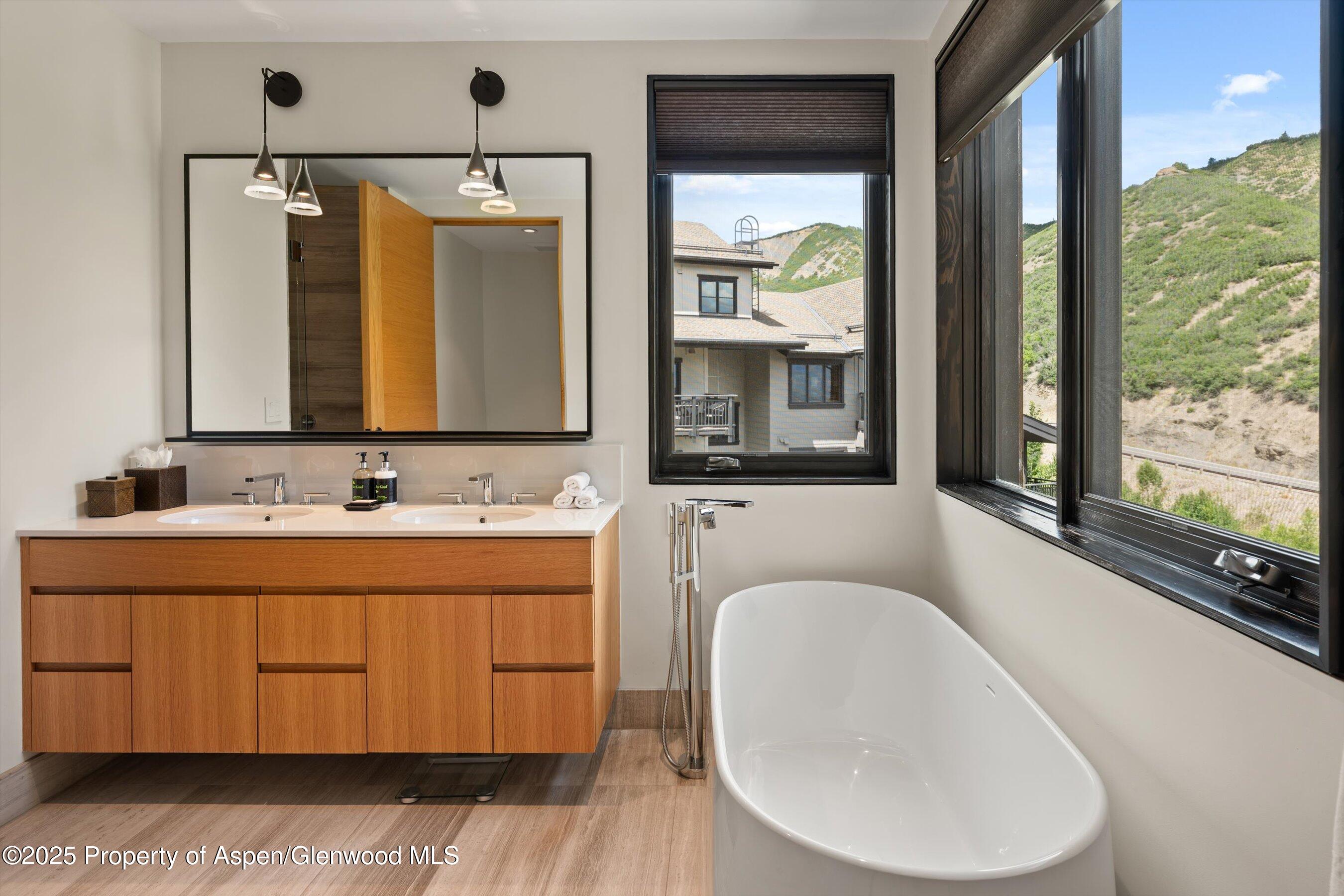 45 Wood Road, Unit 501 Snowmass Village, CO 81615 - Photo 27 of 44 a bathroom with a toilet sink and mirror