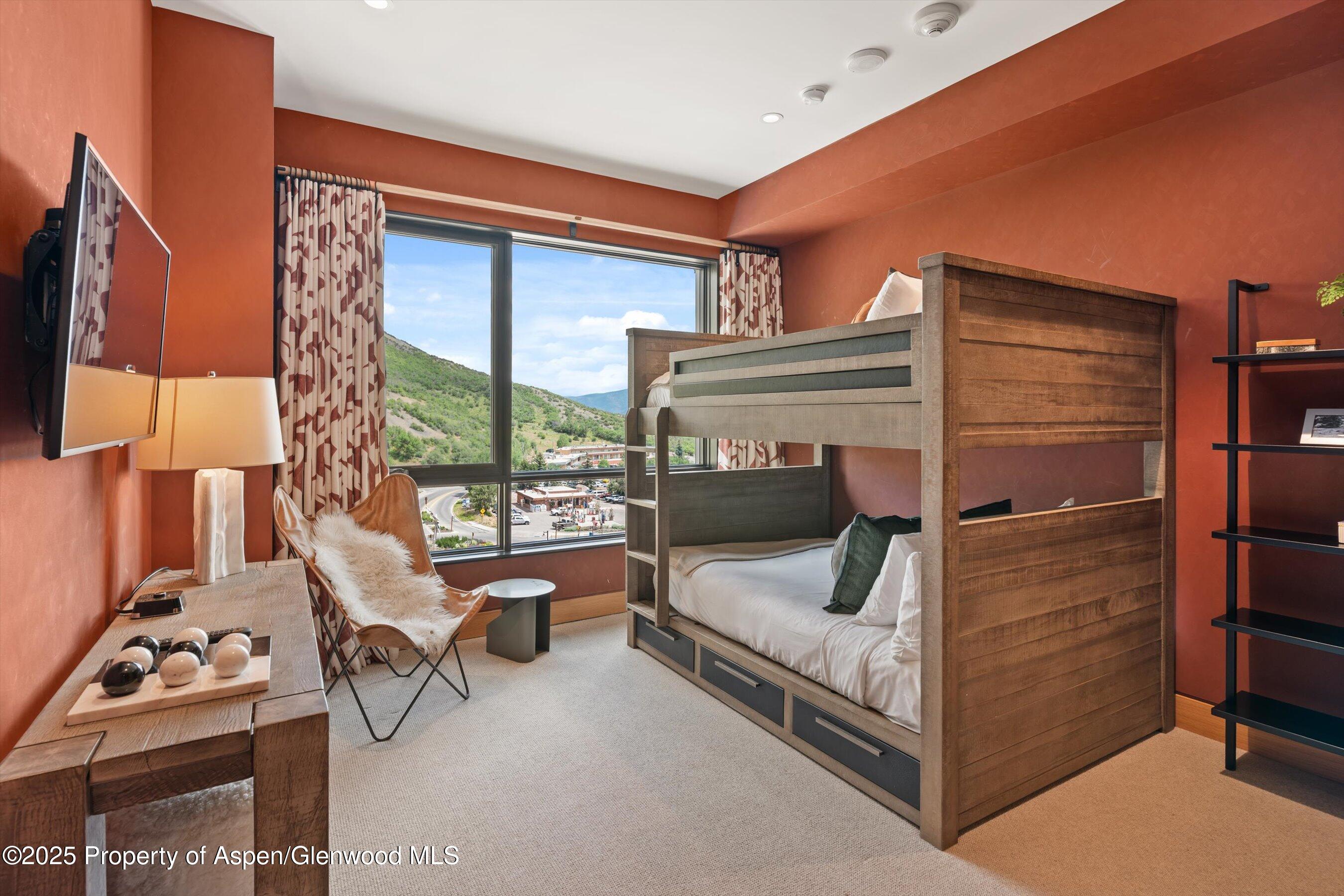 45 Wood Road, Unit 501 Snowmass Village, CO 81615 - Photo 29 of 44 a bedroom with a bed and a window