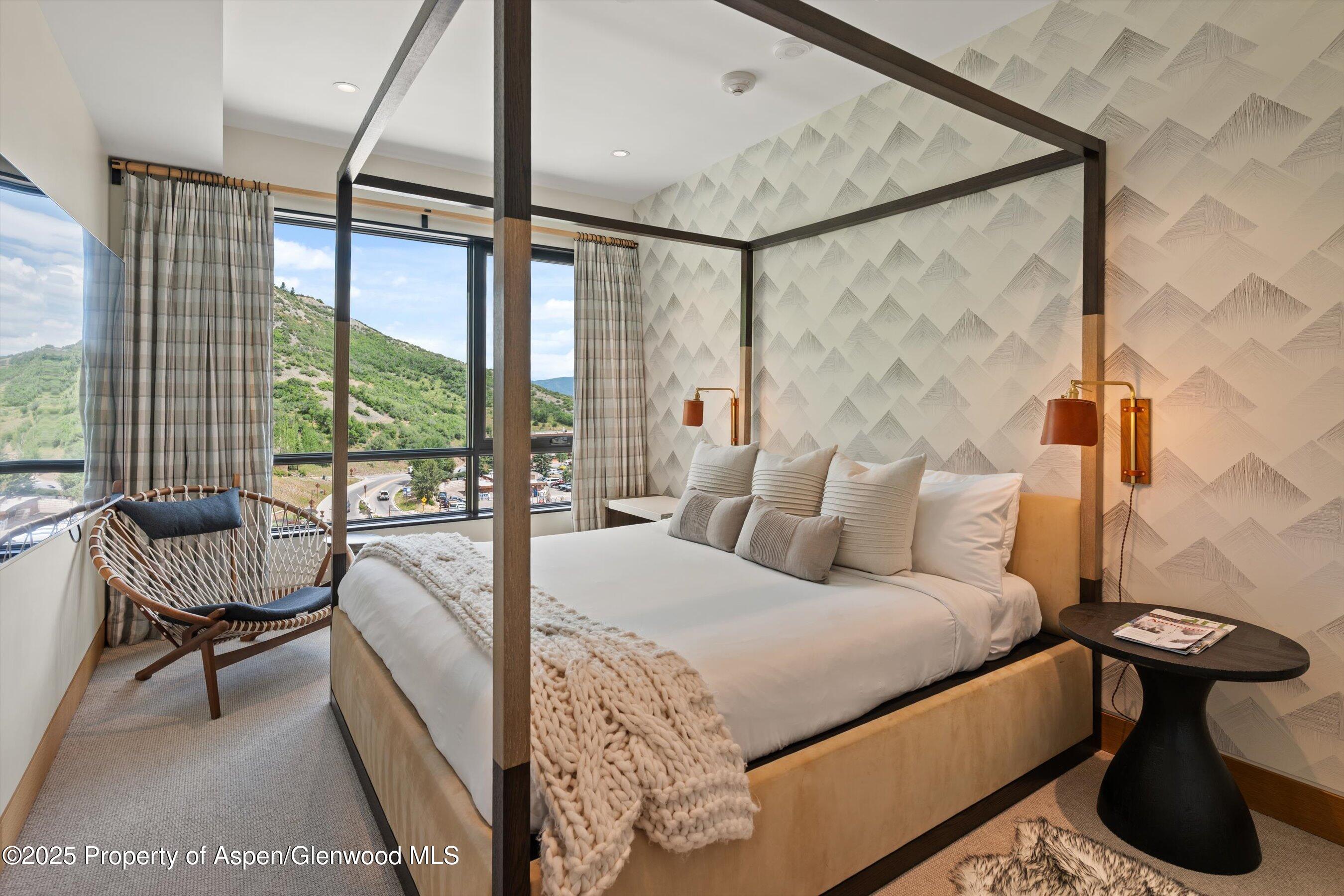 45 Wood Road, Unit 501 Snowmass Village, CO 81615 - Photo 31 of 44 a bedroom with a bed and a large window