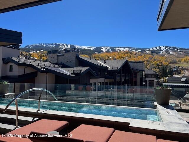 45 Wood Road, Unit 501 Snowmass Village, CO 81615 - Photo 40 of 44 a view of a patio with swimming pool table and chairs