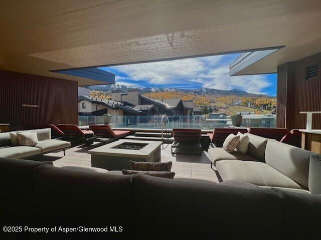 45 Wood Road, Unit 501 Snowmass Village, CO 81615 - Photo 42 of 44 a living room with furniture and a floor to ceiling window