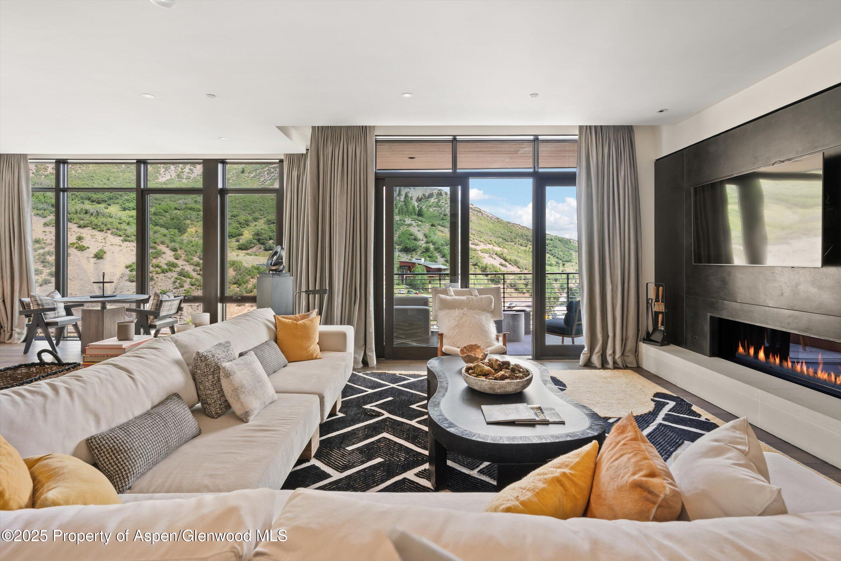 45 Wood Road, Unit 501 Snowmass Village, CO 81615 - Photo 5 of 44 a living room with furniture and large windows
