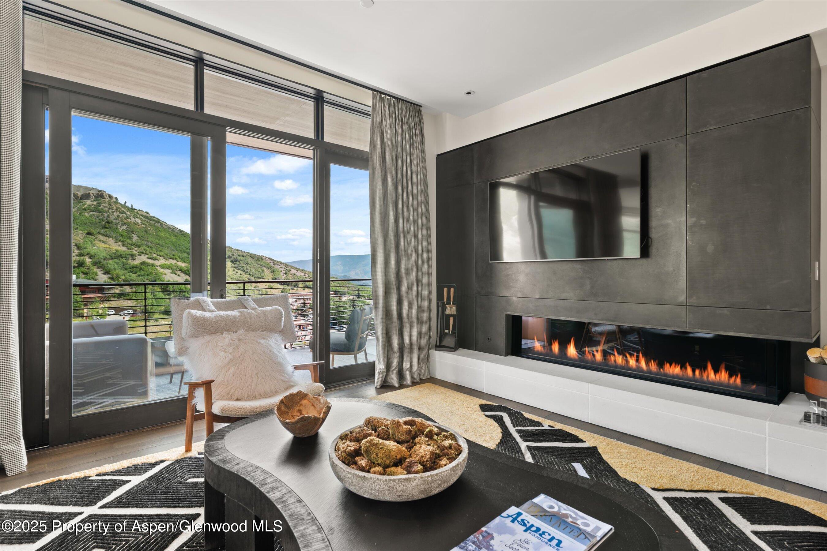 45 Wood Road, Unit 501 Snowmass Village, CO 81615 - Photo 6 of 44 a living room with furniture and a floor to ceiling window