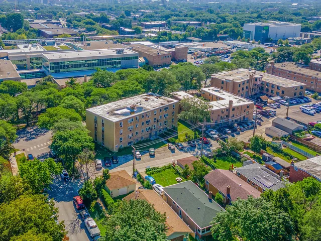 an aerial view of residential houses with outdoor space and parking