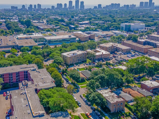 an aerial view of residential houses with city view