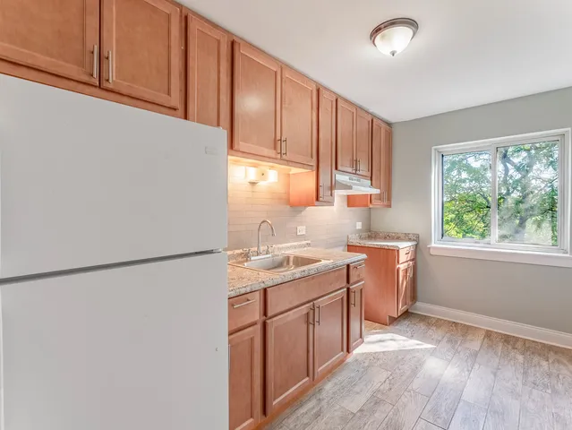 a kitchen with a sink a window and appliances