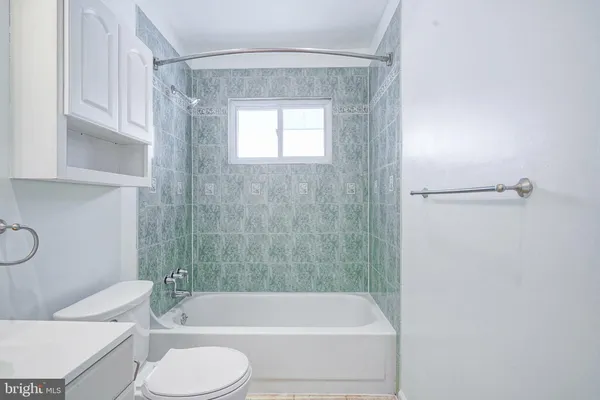 a bathroom with a toilet and a bathtub