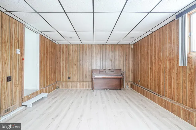 a view of a room with wooden walls and window