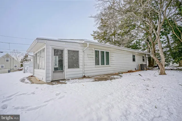 a view of a house with a snow in the yard