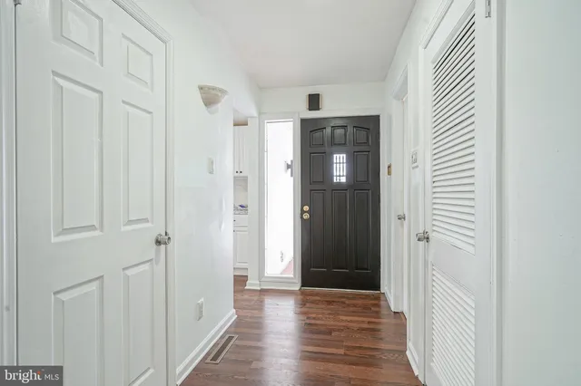 a view of a hallway with wooden floor