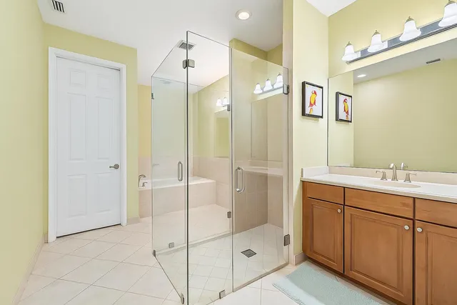 a bathroom with a shower sink and mirror