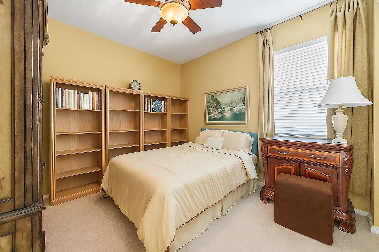 2912 Southwest Porpoise Circle Stuart, FL 34997 - Photo 16 of 37 a bedroom with a bed and a chandelier