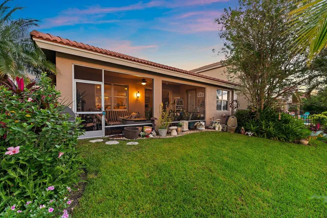 a view of a house with backyard porch and sitting area