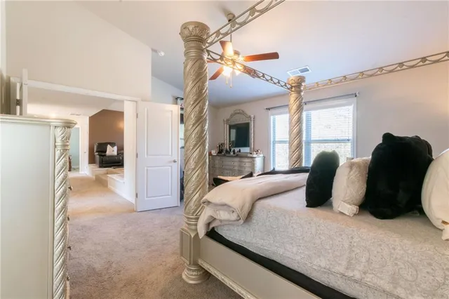 a bedroom with a large bed and a couch