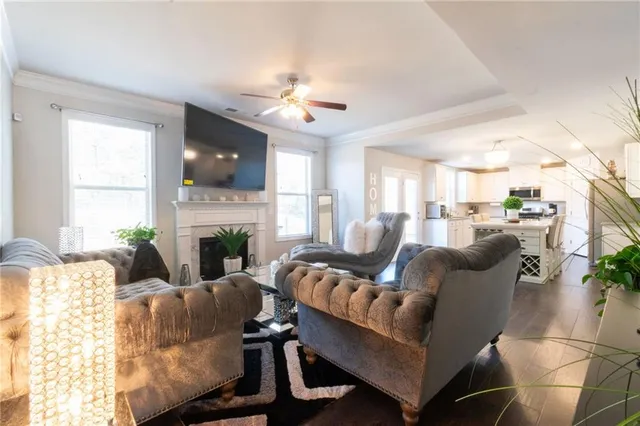 a living room with furniture a flat screen tv and a fireplace