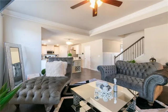 a living room with furniture and a dining table