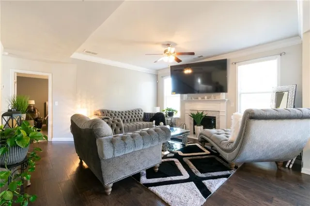 a living room with furniture a flat screen tv and a fireplace