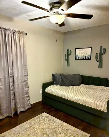 a bedroom with a large bed and a chandelier