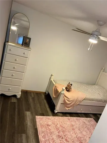 a bedroom with a bed and a mirror