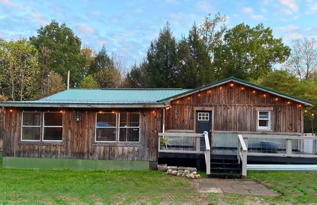 123 Hemlock Lane Utica, PA 16362 - Photo 2 of 30 a front view of a house with a garden