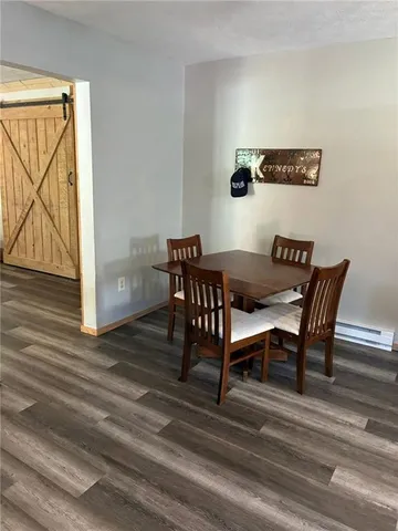 a view of a room with furniture and wooden floor