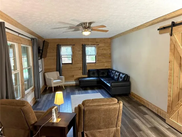 a living room with furniture and wooden floor