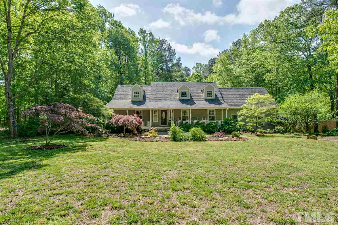 12608 Old Creedmoor Road Raleigh, NC 27613 - Photo 1 of 30 a front view of a house with a yard and trees