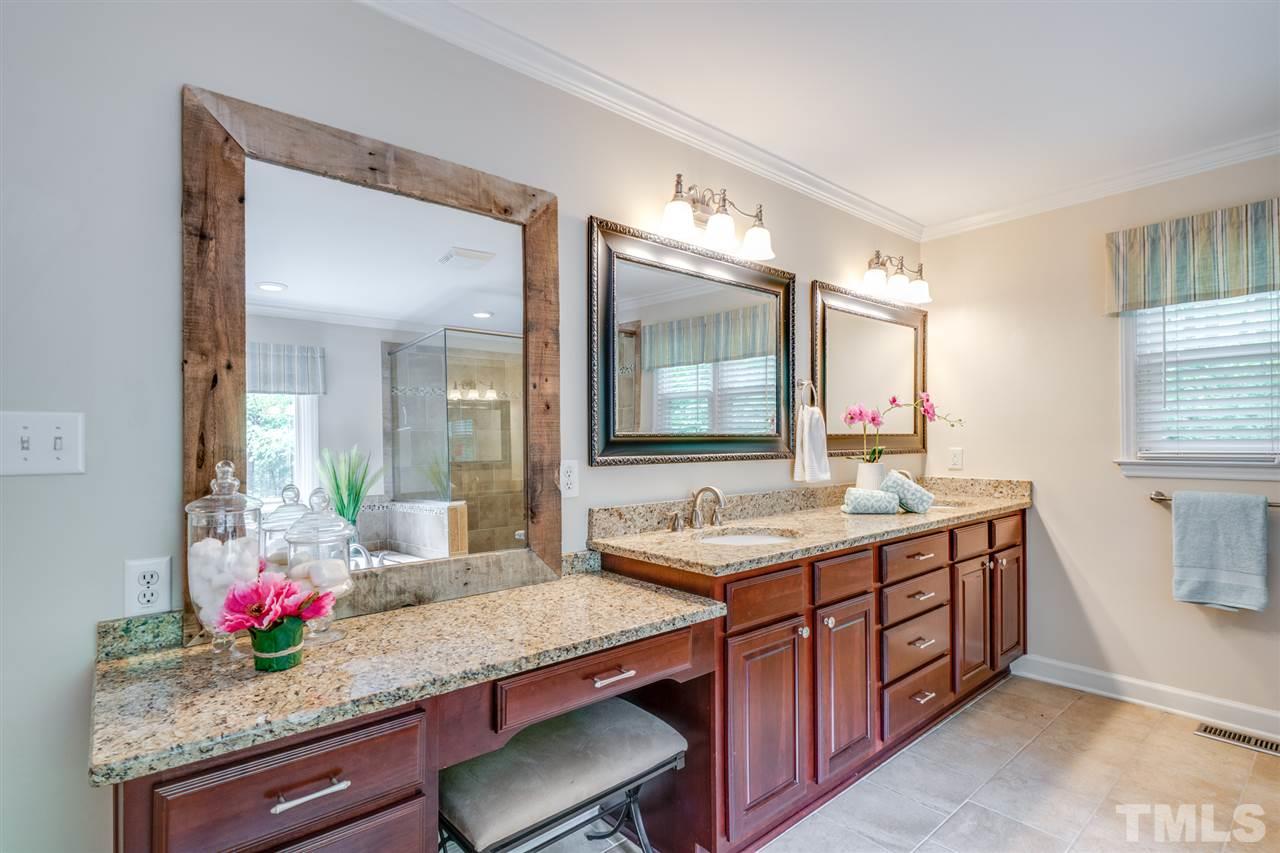 12608 Old Creedmoor Road Raleigh, NC 27613 - Photo 17 of 30 a bathroom with a granite countertop sink and a mirror