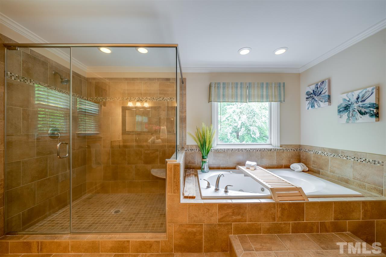 12608 Old Creedmoor Road Raleigh, NC 27613 - Photo 18 of 30 a bathroom with a bathtub and a shower