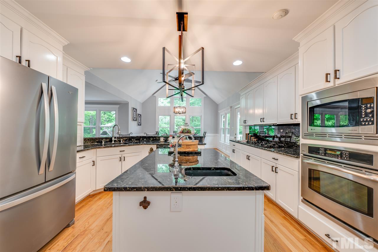 12608 Old Creedmoor Road Raleigh, NC 27613 - Photo 3 of 30 a kitchen with stainless steel appliances granite countertop a refrigerator a stove and a sink