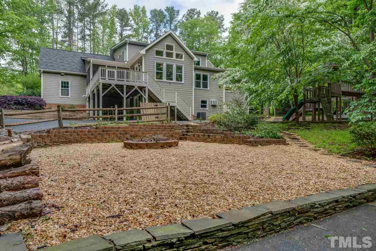 12608 Old Creedmoor Road Raleigh, NC 27613 - Photo 30 of 30 a view of a large house with a yard and large trees