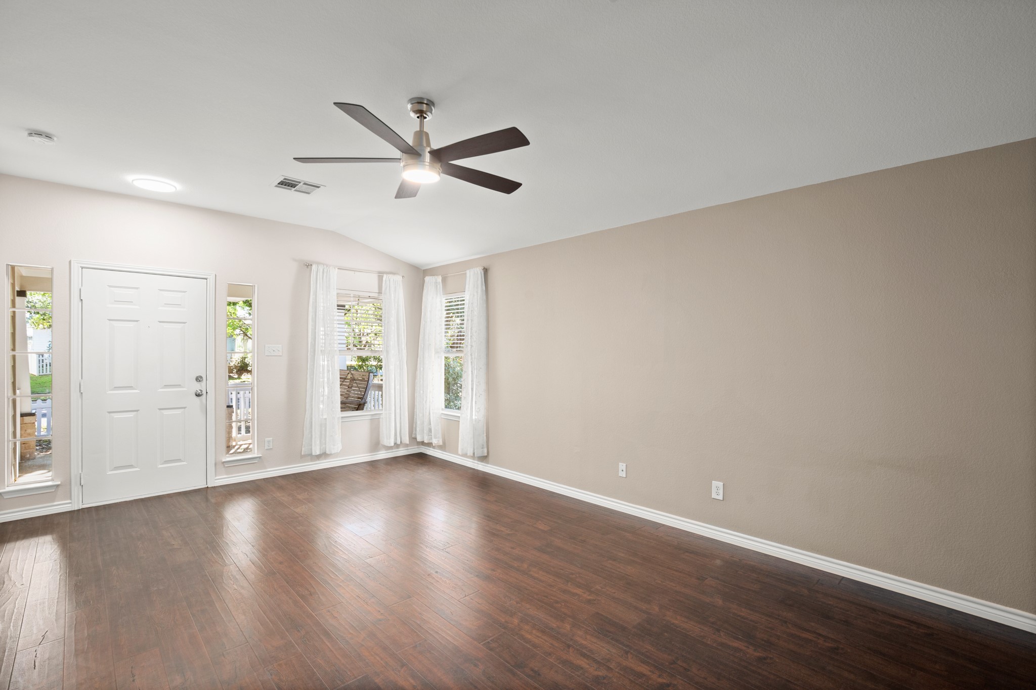 151 Sampson Kyle, TX 78640 - Photo 5 of 23 Those front windows bring in beautiful light while still keeping the mature trees and porch views front and center.