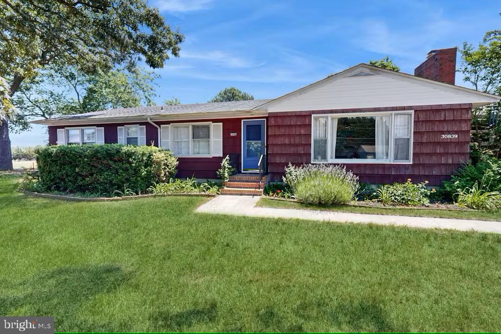 30839 Cedar Neck Road Bethany Beach, DE 19930 - Photo 1 of 17 a front view of a house with a yard and porch