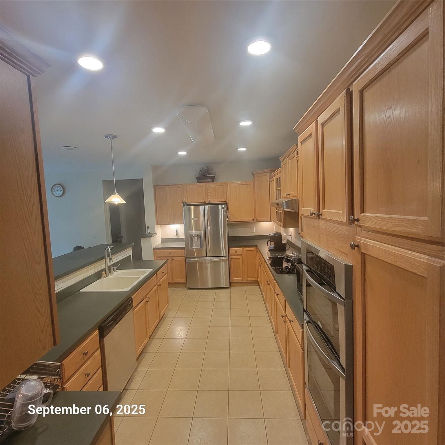 31 Reeds Creek Road Fairview, NC 28730 - Photo 17 of 35 a large kitchen with stainless steel appliances a large counter top a stove and a refrigerator
