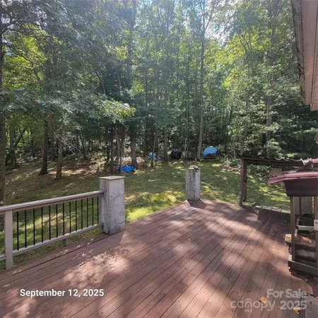 a view of a lake with a bench next to a yard