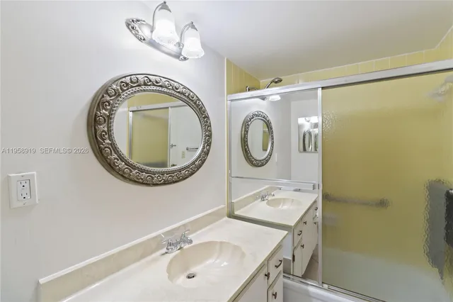 a bathroom with a sink a mirror and a shower curtain
